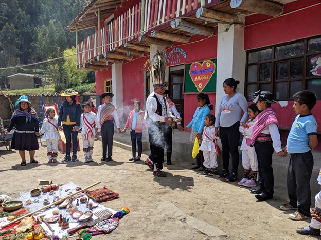 Adults and children taking part in a local ceremony.