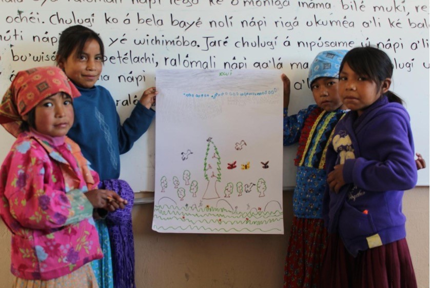 Group of school children showing the picture they have drawn.