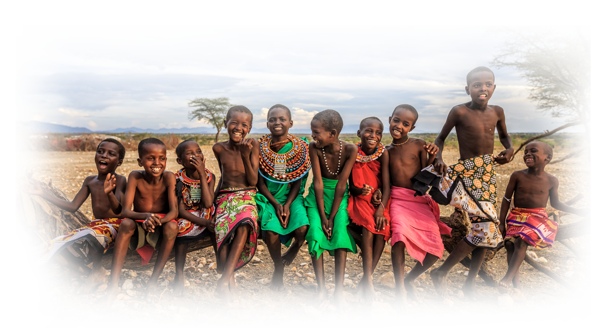 Image of children smiling and wearing colorful clothing.